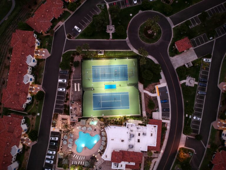 An aerial view of a tennis court at night.