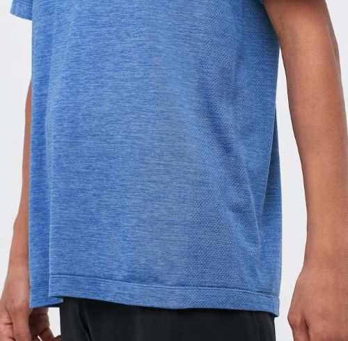 The back view of a boy wearing a blue t - shirt.