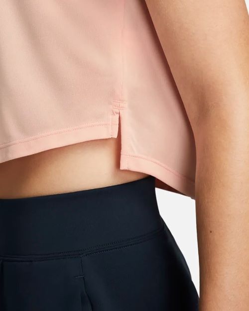 The back view of a woman wearing a pink crop top.