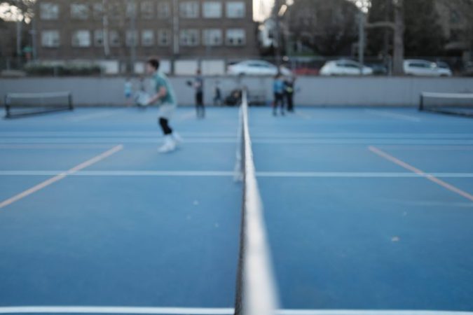 Pickleball players playing on a pickleball court.