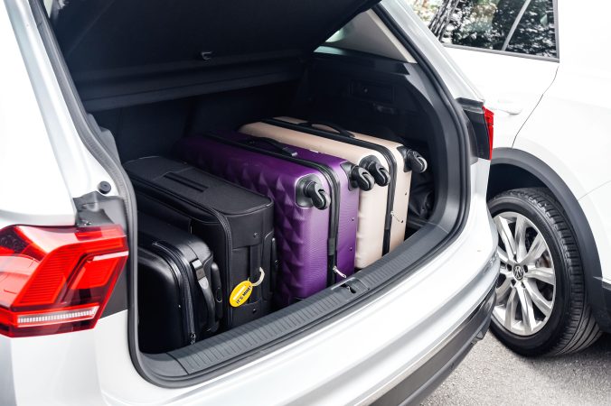 Trunk of car open with luggage inside