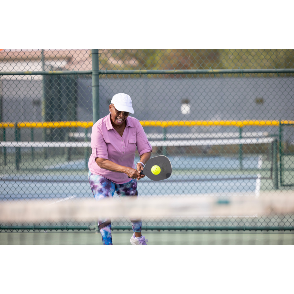A woman playing tennis on a tennis court.