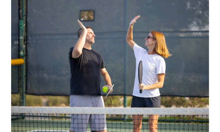 Male and female pickleball players competing in mixed doubles.